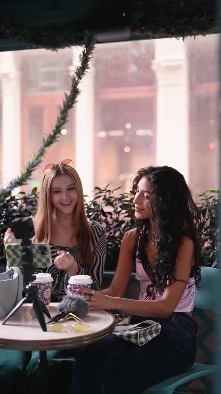 Two creators filming coffee content on a patio